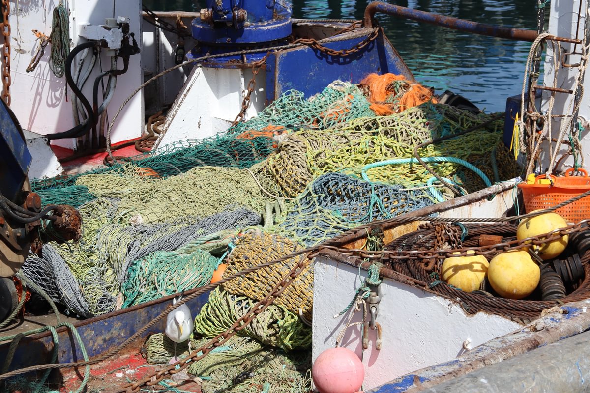 Various fishing nets stacked up on a fishing vessel.