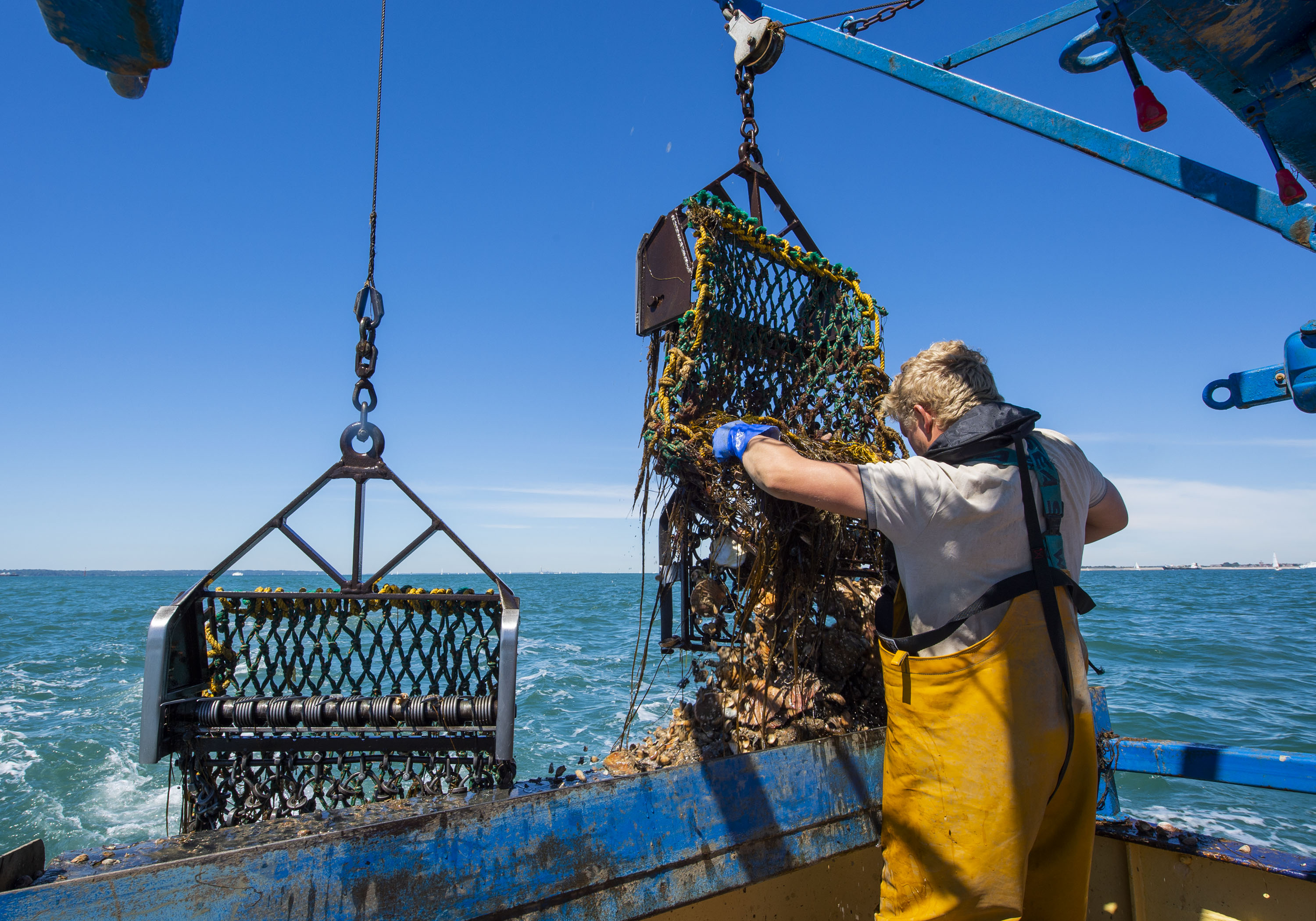 Fisherman working safely on deck out at sea