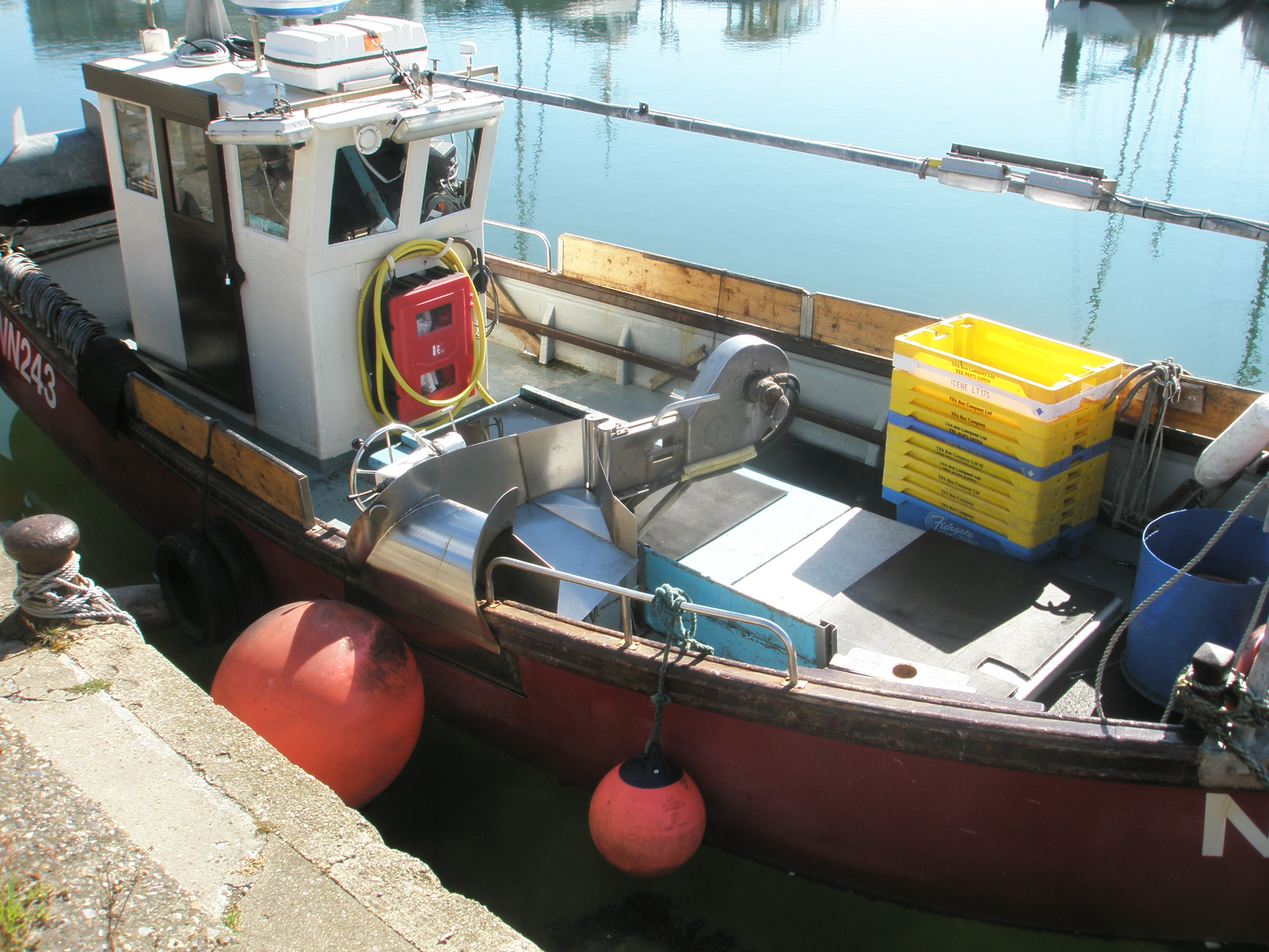 Inshore vessel with line hauler onboard docked at harbour