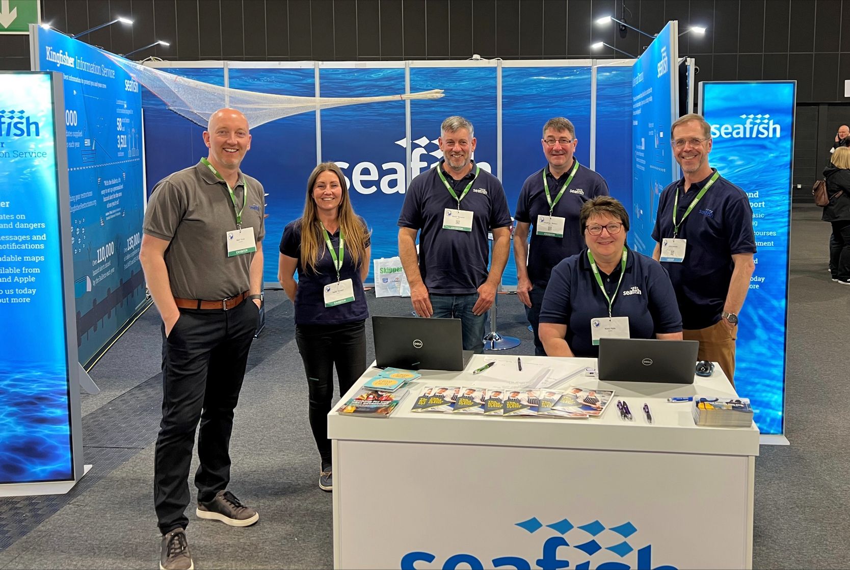 People standing at an exhibition stall at a trade show